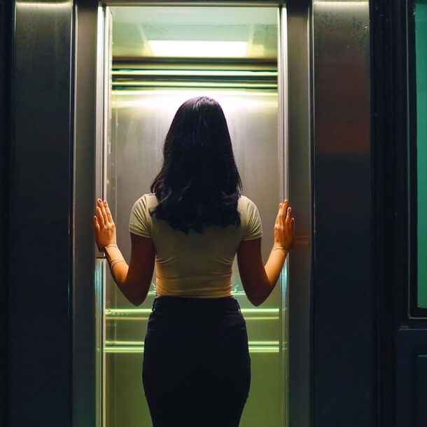 woman standing between elevator doors symbolizing the The-Countdown Deepening Technique